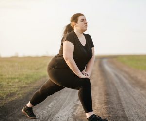  Girl stretching legs on dirt road